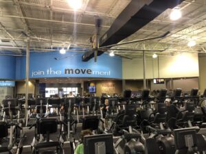 Interior of Just Move gym in Lakeland, Florida with strength equipment, turf track, and cycling studio