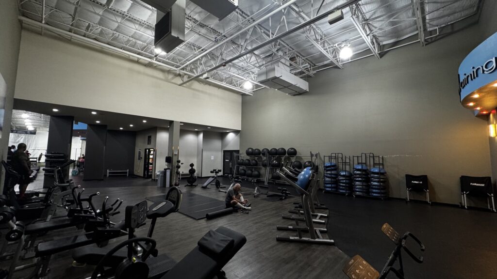 Member doing post workout stretches on a mat in the Abs & Stretching Area at Just Move Athletic Club