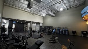 Member doing post workout stretches on a mat in the Abs & Stretching Area at Just Move Athletic Club